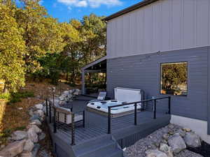 Wooden deck featuring a hot tub