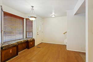 Entrance foyer with light wood-type flooring