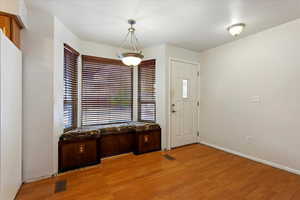 Foyer with light hardwood / wood-style floors