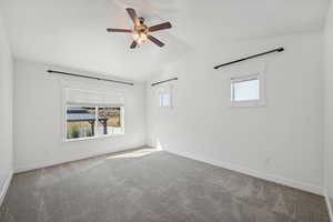 Unfurnished room with lofted ceiling, carpet, and ceiling fan