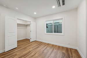 Unfurnished bedroom with a closet and light wood-type flooring