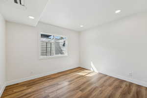 Unfurnished room with hardwood / wood-style floors