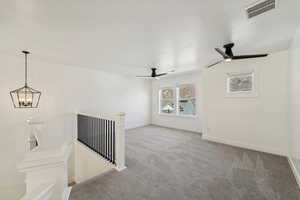 Unfurnished living room featuring light colored carpet and ceiling fan