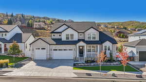 View of front of property featuring a mountain view and a garage