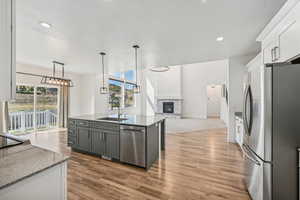 Kitchen with white cabinetry, stainless steel appliances, sink, and plenty of natural light