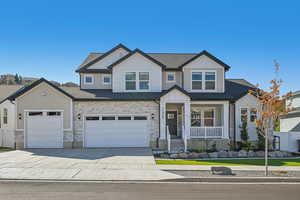 Craftsman house with a porch and a garage