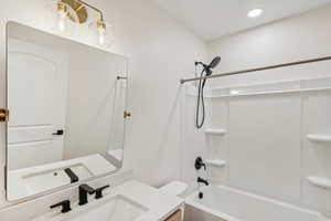 Full bathroom featuring vanity, shower / washtub combination, and toilet