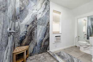 Bathroom featuring cooling unit, walk in shower, tile walls, toilet, and tile patterned floors