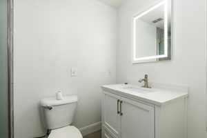 Bathroom featuring toilet and vanity