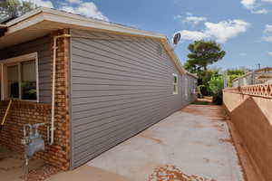 View of side of home with a patio