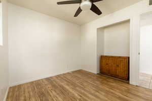 Spare room with light wood-type flooring and ceiling fan