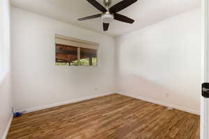 Unfurnished room with wood-type flooring and ceiling fan