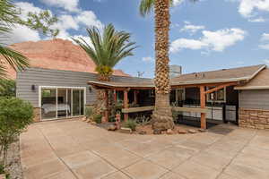 Rear view of house with a mountain view and a patio area