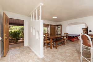 Dining space with light tile patterned flooring