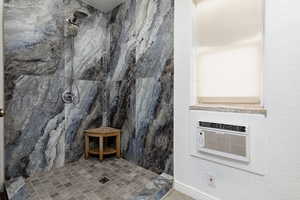 Bathroom featuring tiled shower and cooling unit