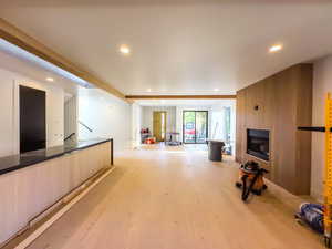 Unfurnished living room featuring light wood-type flooring and a fireplace