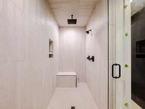 Bathroom featuring a shower with door