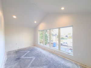 Spare room featuring lofted ceiling