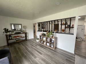 Interior space with a textured ceiling and hardwood / wood-style floors