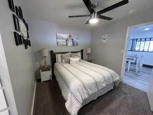 Bedroom with dark carpet and ceiling fan