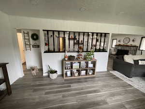 Interior space with hardwood / wood-style floors, a fireplace, and a textured ceiling