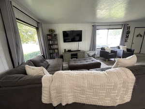 Living room featuring a healthy amount of sunlight, a textured ceiling, and hardwood / wood-style floors