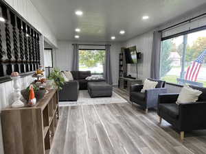 Living room featuring hardwood / wood-style flooring, a textured ceiling, and a wealth of natural light