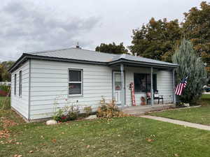 View of front of home with a front lawn and a porch