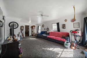 Living room with carpet flooring and ceiling fan