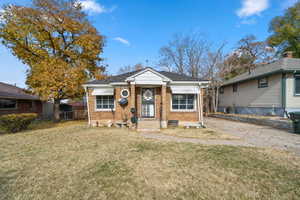 Bungalow-style house featuring a front yard