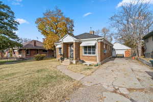 Bungalow-style home with central AC unit and a front lawn