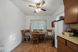 Dining area featuring a textured ceiling, hardwood / wood-style flooring, and ceiling fan