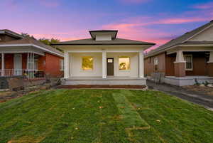 View of front of house featuring a yard and a porch