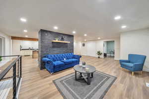 Living room with light hardwood / wood-style floors