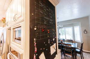 Wine area featuring a textured ceiling and a chandelier