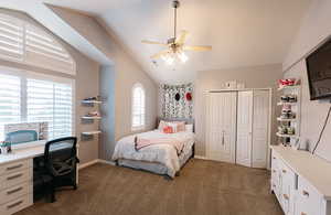 Bedroom featuring multiple windows, dark carpet, and ceiling fan