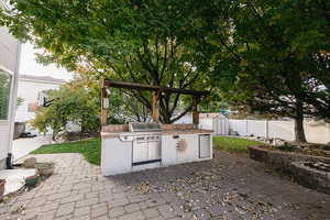 View of patio featuring sink, exterior kitchen, and area for grilling