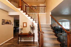 Stairway featuring an elegant 9FT vaulted ceiling and hardwood oak flooring