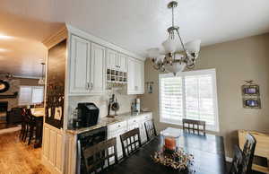 Butler pantry with light stone granite countertops, beverage cooler