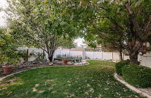 View of yard featuring a patio area with various fruit bearing trees like peach, pear, and Asian pear