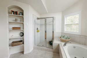 Bathroom featuring separate shower and tub, built in features, and tile patterned flooring