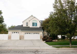 View of front property with a front yard and a garage