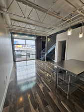 Living Room with Amazing Custom Roll-Up Garage Doors on 2 Levels with Railing!