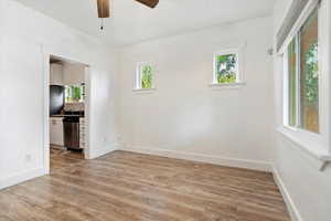 Empty room featuring light hardwood / wood-style flooring and ceiling fan