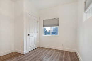 Empty room with light hardwood / wood-style flooring