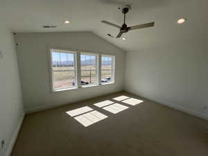 Carpeted empty room featuring visible vents, a ceiling fan, recessed lighting, and lofted ceiling