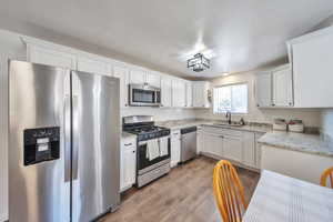 Kitchen features stainless steel appliances and granite countertops