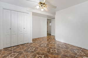 Unfurnished bedroom featuring a closet and ceiling fan