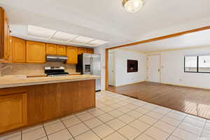 Kitchen featuring light hardwood / wood-style floors, appliances with stainless steel finishes, sink, and backsplash