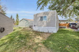 View of property exterior featuring a lawn